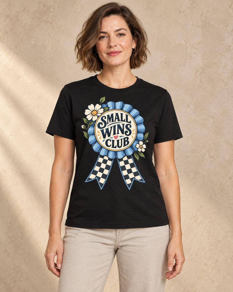 Small Wins Club graphic on a Black regular-fit T-shirt, model front view