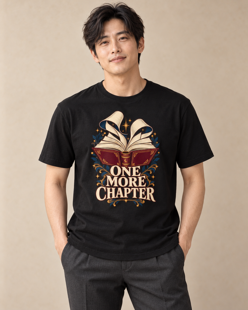 Adult model wearing a black regular fit crew neck T-shirt with the One More Chapter graphic.